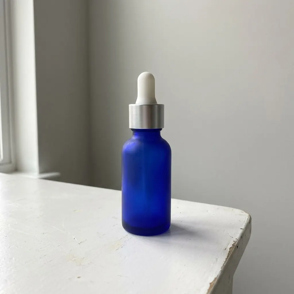 Seller's photo of the blue dropper bottle on a white shelf.